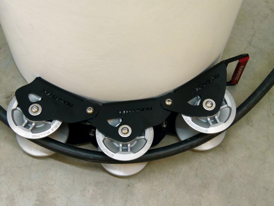 The Runpotec cable guide roller can be used for pulling cables gently around corners with the least possible resistance - example picture showing SWA cable running around a concrete post 